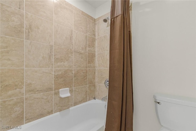 bathroom featuring shower / bath combo with shower curtain and toilet