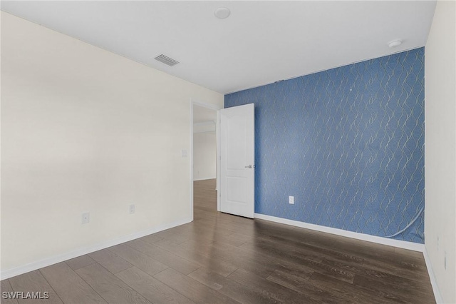 unfurnished room featuring dark wood-type flooring