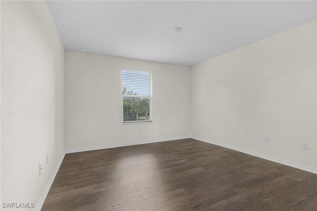 spare room featuring dark wood-type flooring