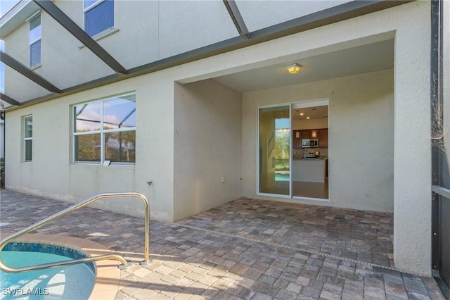 view of patio / terrace featuring a lanai and a swimming pool