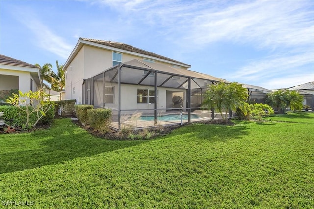 rear view of property featuring glass enclosure and a lawn