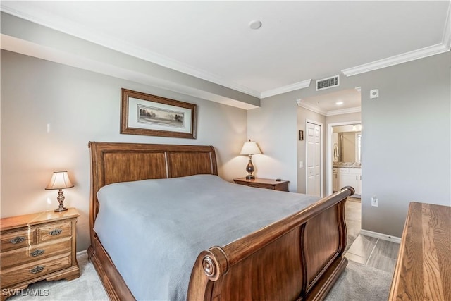 bedroom with ensuite bathroom, a closet, crown molding, and light wood-type flooring