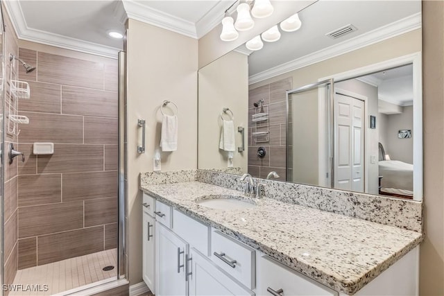 bathroom featuring vanity, an enclosed shower, and crown molding