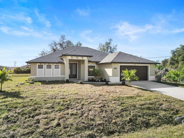 view of front of property with a garage and a front yard