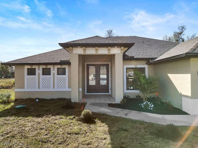 doorway to property with a lawn