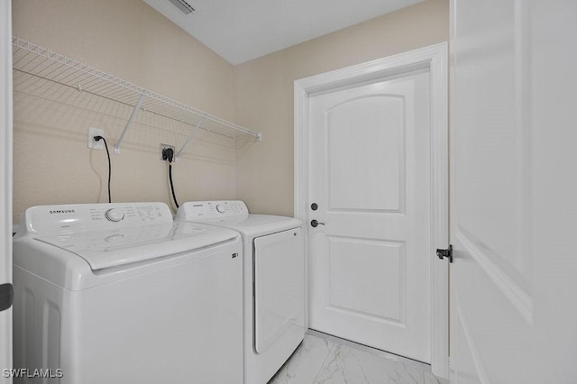 laundry area with washing machine and clothes dryer