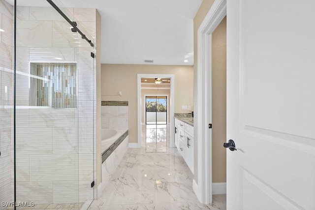 bathroom with vanity and independent shower and bath