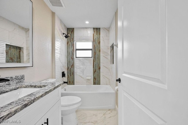 full bathroom featuring toilet, vanity, and tiled shower / bath