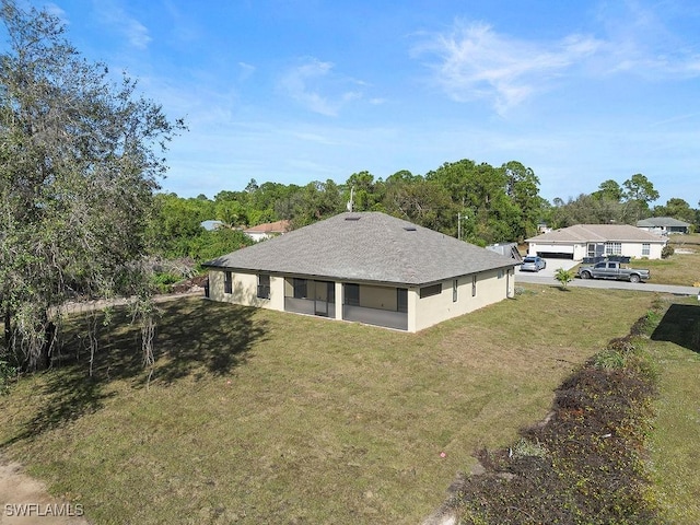 rear view of property featuring a yard