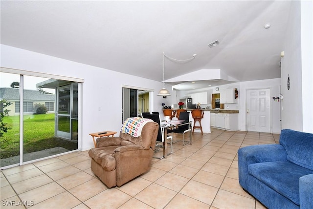 tiled living room with lofted ceiling