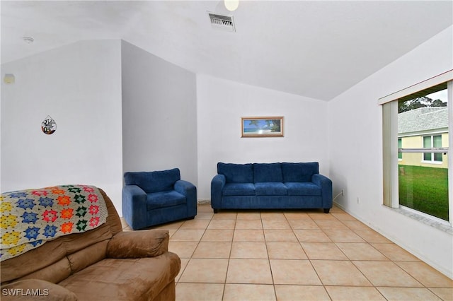 living room with light tile patterned flooring and lofted ceiling