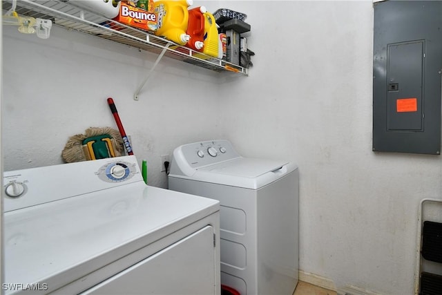 washroom with electric panel and washer and clothes dryer