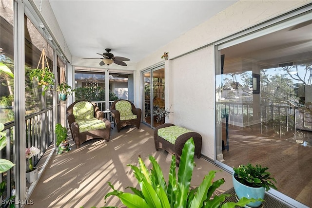 sunroom / solarium featuring ceiling fan