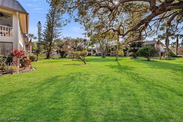 1549 Sandpiper St Unit 80, Naples, FL 34102 - view of green lawn featuring a ceiling fan