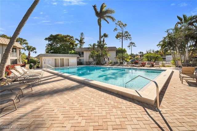 view of pool featuring a patio area and an outdoor structure