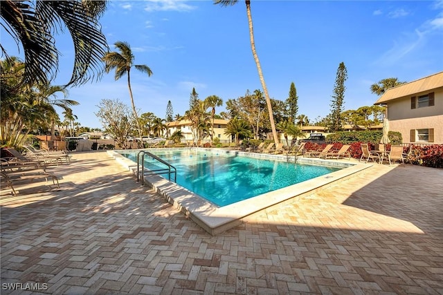 1549 Sandpiper St Unit 80, Naples, FL 34102 - community pool featuring a patio area