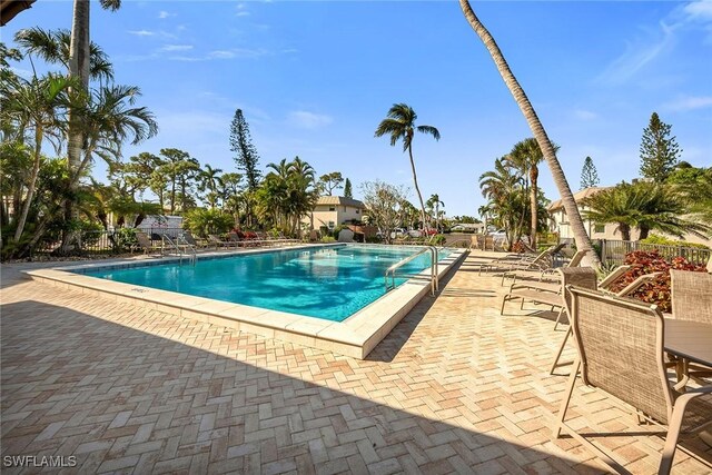 1549 Sandpiper St Unit 80, Naples, FL 34102 - community pool with a patio area