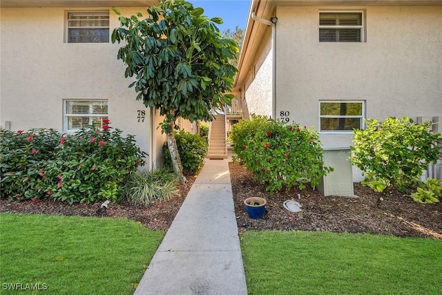 1549 Sandpiper St Unit 80, Naples, FL 34102 - entrance to property featuring stucco siding and a yard
