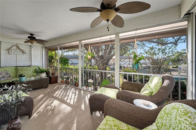 sunroom / solarium featuring ceiling fan