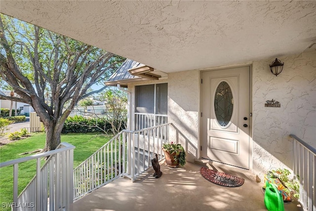 doorway to property with a yard