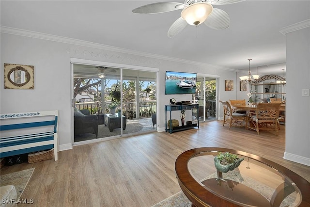 1549 Sandpiper St Unit 80, Naples, FL 34102 - living room with wood finished floors, crown molding, healthy amount of natural light, a ceiling fan, and a chandelier