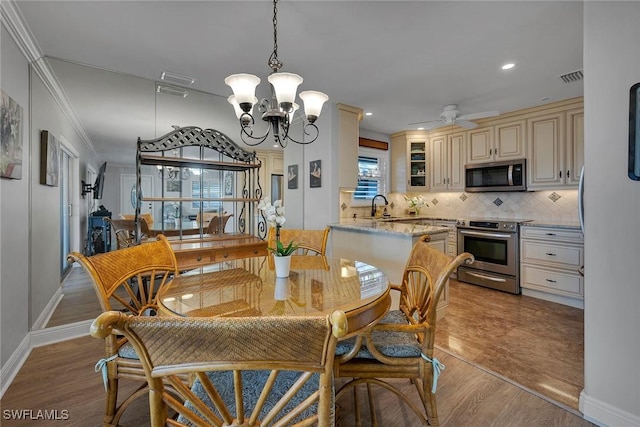1549 Sandpiper St Unit 80, Naples, FL 34102 - dining room with a chandelier, ornamental molding, light wood finished floors, recessed lighting, and ceiling fan