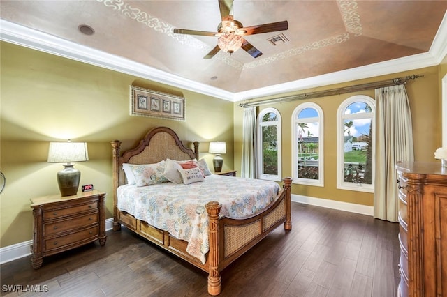 bedroom featuring a tray ceiling, ceiling fan, ornamental molding, and dark hardwood / wood-style floors