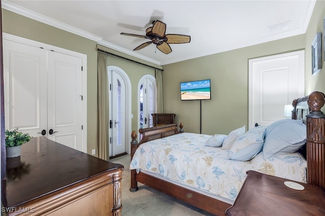 carpeted bedroom featuring ceiling fan and ornamental molding