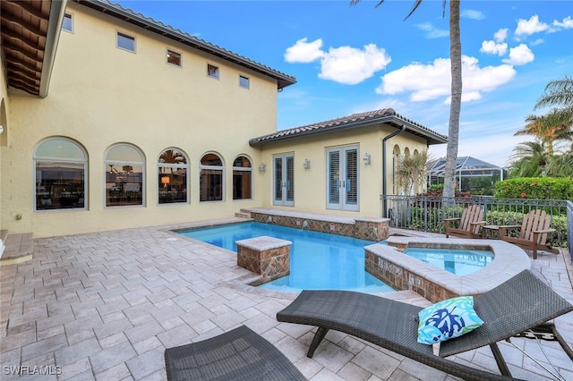 view of pool with an in ground hot tub and a patio