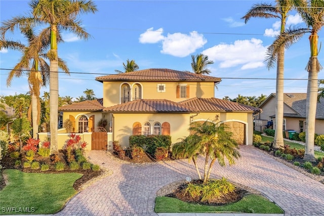 mediterranean / spanish home featuring a garage