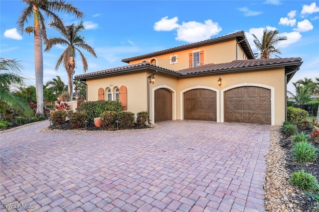 mediterranean / spanish house featuring a garage