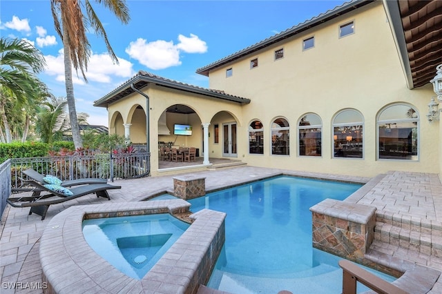 view of pool featuring a patio area and an in ground hot tub