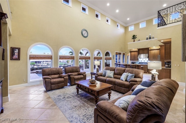 living room featuring a high ceiling and ornamental molding