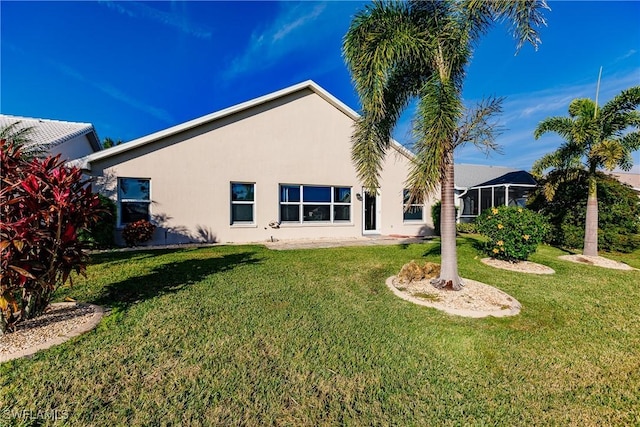 rear view of property with a yard