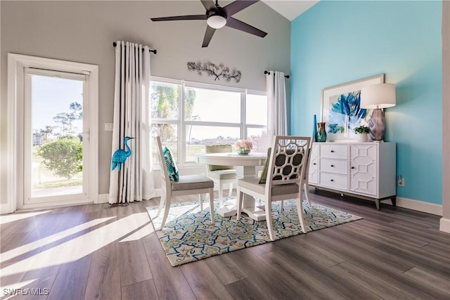 dining area with dark hardwood / wood-style floors, high vaulted ceiling, plenty of natural light, and ceiling fan