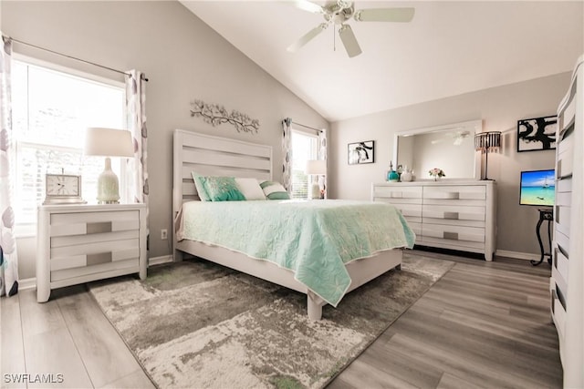 bedroom with ceiling fan, high vaulted ceiling, and hardwood / wood-style flooring