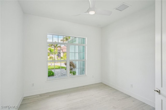 spare room featuring ceiling fan and light hardwood / wood-style flooring