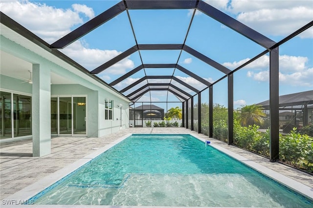 view of swimming pool with a lanai and a patio