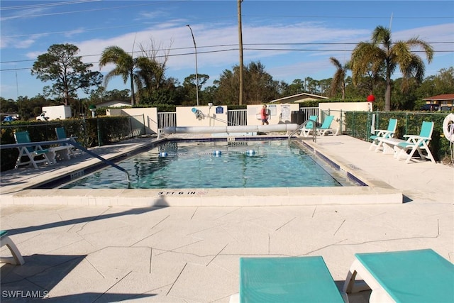 view of swimming pool with a patio