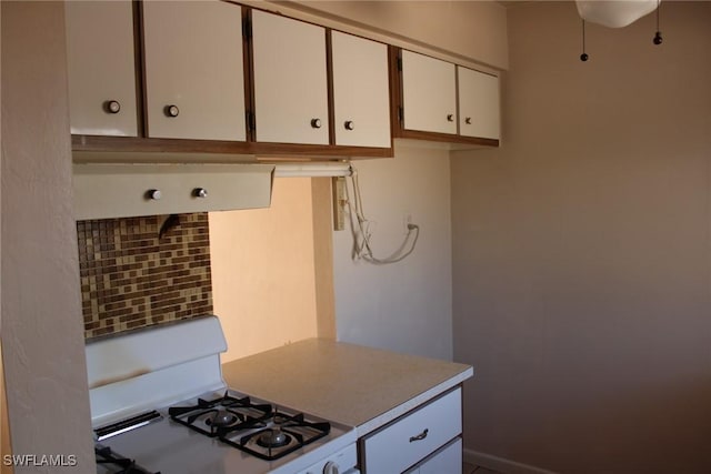 kitchen with white cabinets and white range with gas cooktop