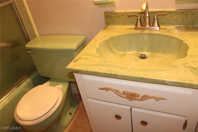 bathroom featuring toilet, vanity, and tile patterned floors