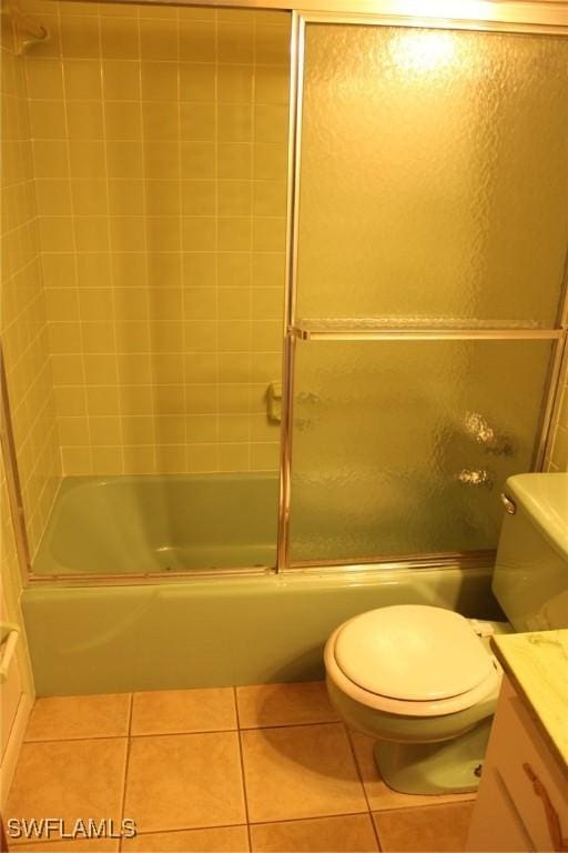 full bathroom with toilet, vanity, tile patterned floors, and shower / bath combination with glass door