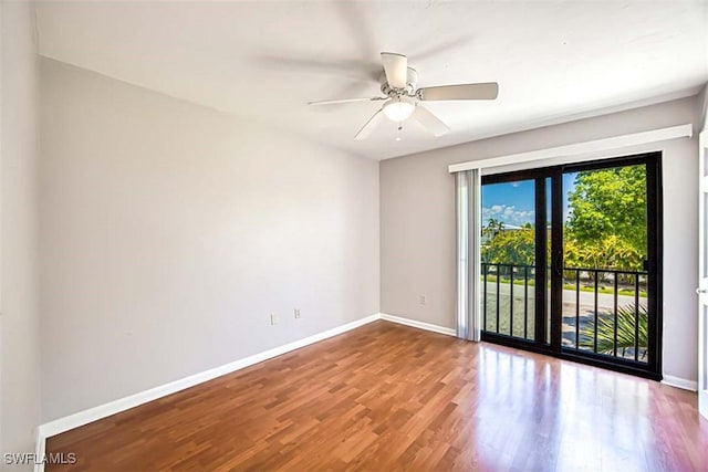 spare room with hardwood / wood-style flooring and ceiling fan