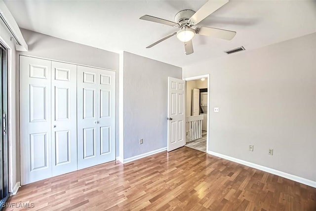 unfurnished bedroom featuring a closet, light hardwood / wood-style floors, and ceiling fan