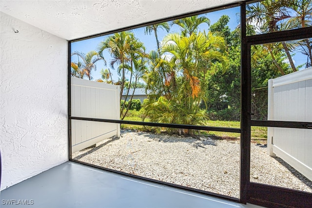 doorway with concrete flooring and a healthy amount of sunlight