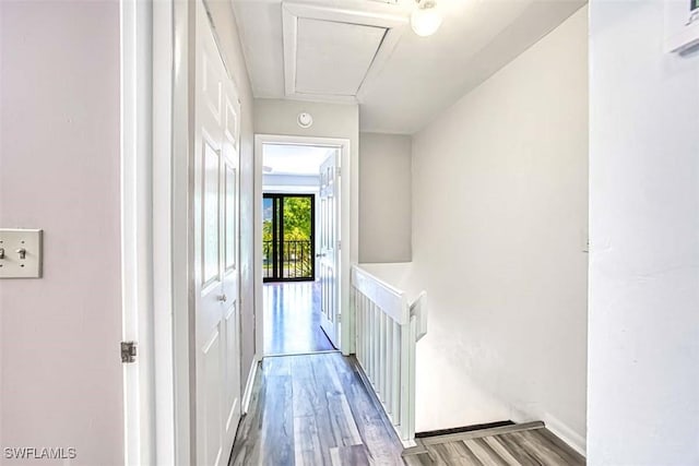 hallway with hardwood / wood-style floors