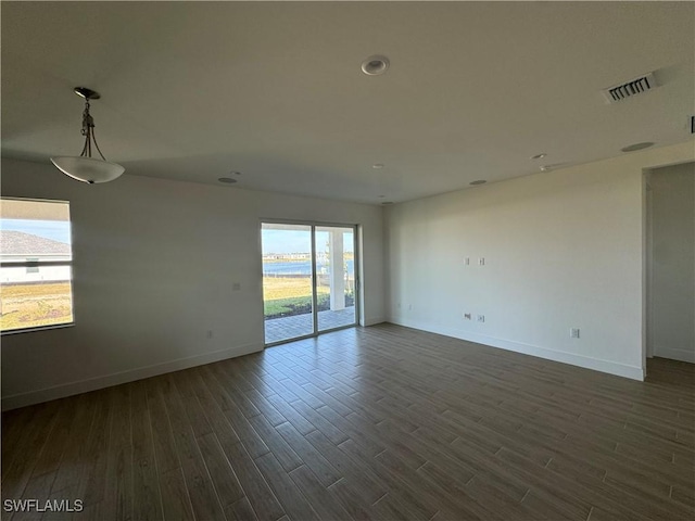 empty room with dark hardwood / wood-style flooring