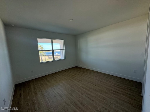 empty room featuring dark wood-type flooring