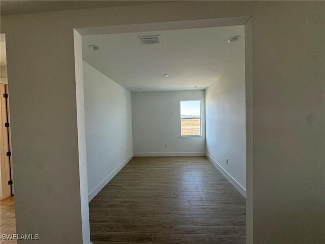 empty room with hardwood / wood-style floors