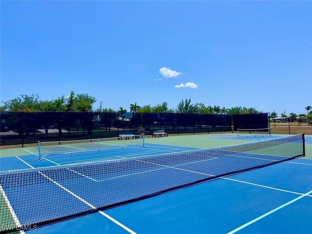 view of tennis court featuring basketball hoop